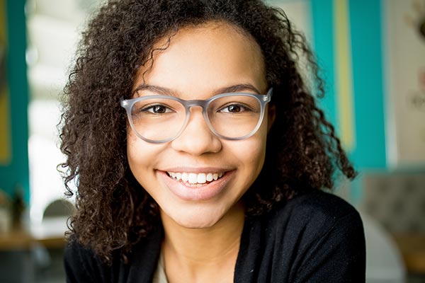Young girl smiling wearing glasses